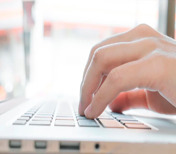 A man is typing on a keyboard